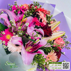 Vibrant Fuchsia Pink Lily and Rose Bouquet in Purple Wrapping